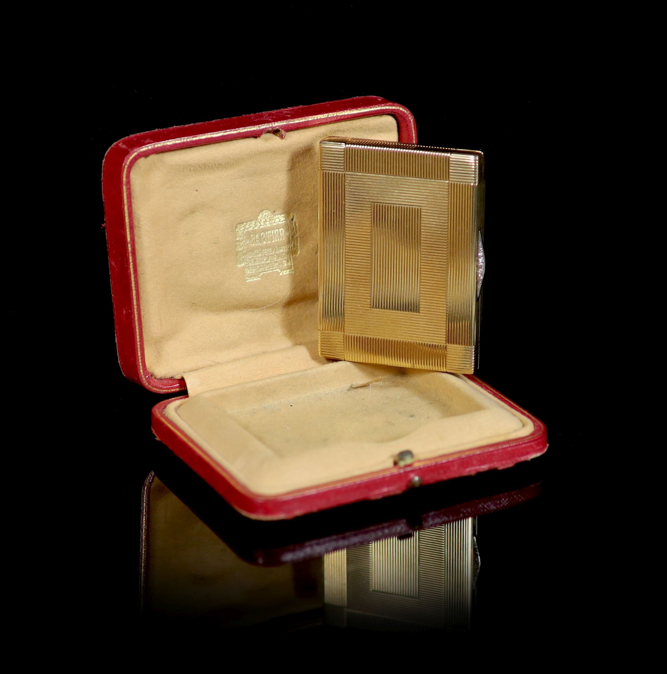 A 1930's Cartier 9ct gold compact, with diamond set thumbpiece